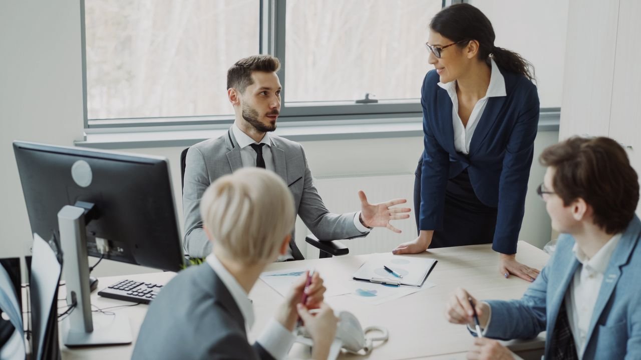 Professional team having a discussion in a modern office environment.